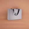 The white handbag is a simple and solid-colored eco-friendly shopping bag with a large capacity and foldable portability details Picture